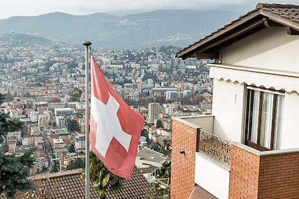 Weltweiter Elend-Index: Die Schweiz hat den tiefsten Wert Eigenheim mit Schweizer Flagge am Hang des Monte Bre in Lugano (Nov. 2015).