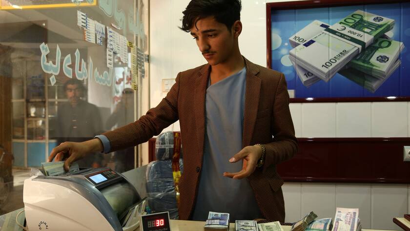 Ein afghanischer Geldwechsler zählt US-Dollar-Banknoten auf einem Geldwechselmarkt in der Provinz Ghazni im Osten Afghanistans.