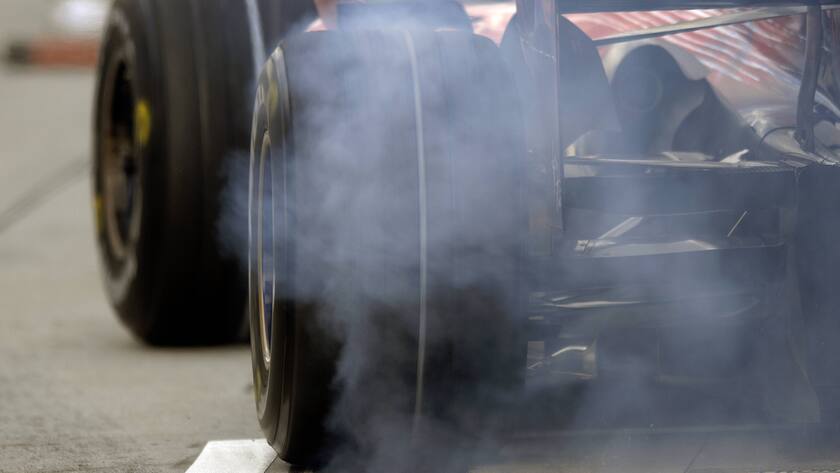 Ein Bolide verlässt mit qualmenden Reifen die Boxengasse.