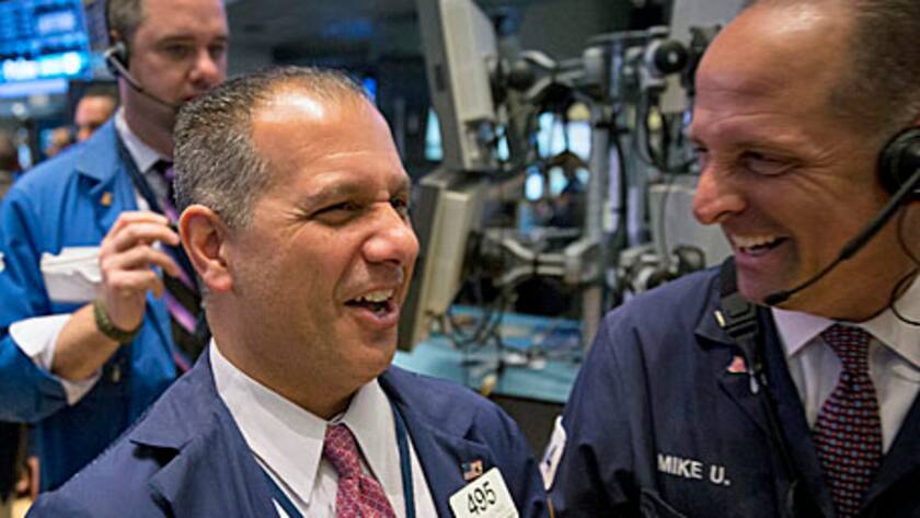 Traders share a laugh at the New York Stock Exchange (NYSE) in New York, U.S., on Tuesday, April 30, 2013.