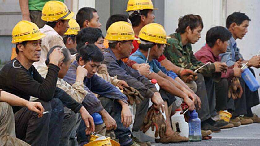 Workers take a rest outside a construction site in Shanghai, China, on Sunday, June 30, 2013.