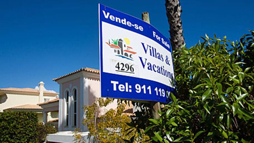 A sale sign stands on a roadside outside a luxury villa in Almancil, Algarve region, Portugal, on Saturday, March 9, 2013.