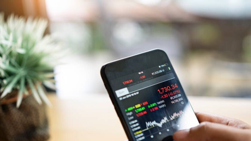 businessman using a mobile phone to check stock market data