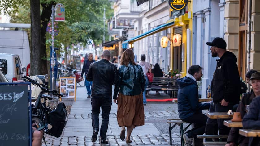 Gäste sitzen vor Cafés und Bars in der Stargarder Strasse in Berlin-Prenzlauer Berg.