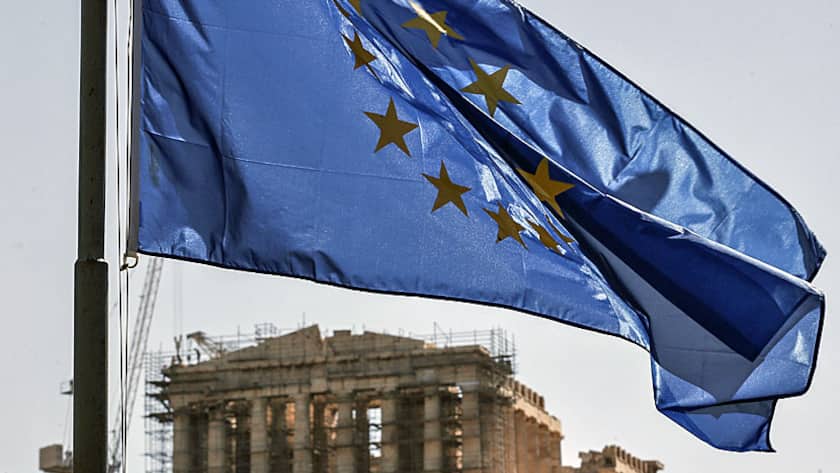 A European Union (EU) flag flies in front of the Parthenon temple on Acropolis Hill in Athens, Greece, on Wednesday, July 8, 2015.