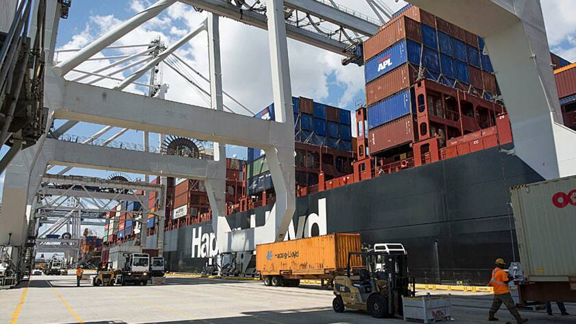 Containers sit on trucks before being loaded onto cargo ships at the Port of Savannah in Savannah, Georgia, U.S., on Friday, Aug. 14, 2015.