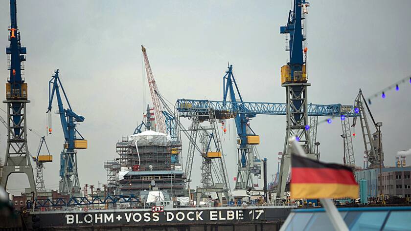 Shipping cranes stand at Blohm + Voss shipyard, operated by Star Capital Partners Ltd., as a German national flag flies at Hamburg port in Hamburg, Germany, on Thursday, Jan. 14, 2016.