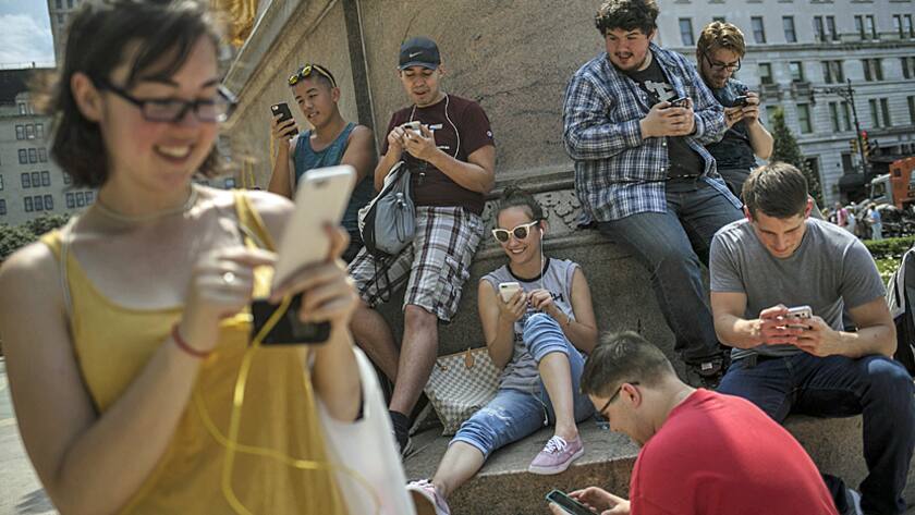 Gamers play the Nintendo Co. Pokemon Go game on Fifth Avenue in New York, U.S., on Wednesday, July 13, 2016.