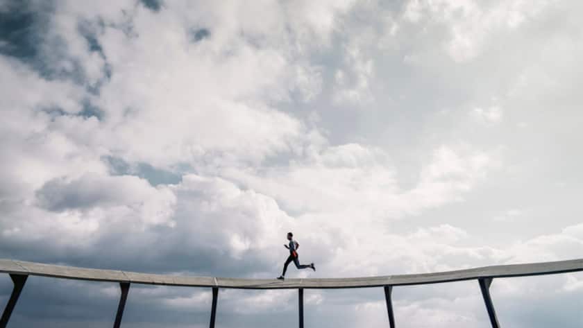 Stock Photo of Strong Healthy Male Athlete Running on Elevated Track