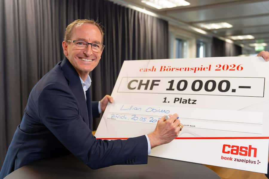 Marcel Gamper, Leiter Direct Clients Bank Zweiplus, mit dem symbolischen Check für die Börsenspiel-Siegerin Lillian Obimo.